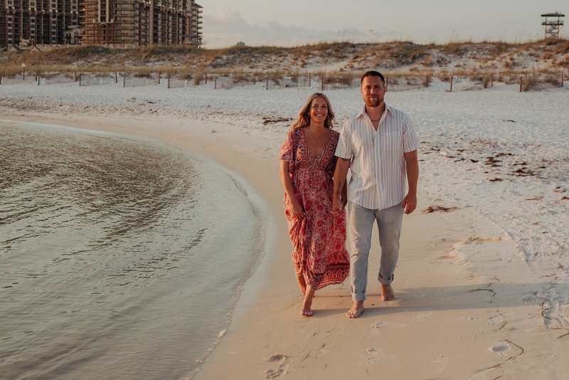 Liz walking a shoreline at sunset